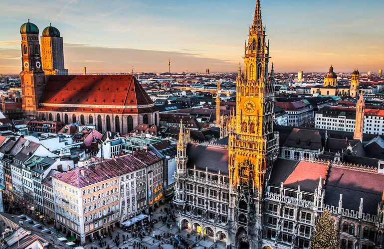 Sunset view over Munich from the New Town Hall tower with historic rooftops and city skyline