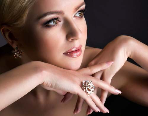 elegant woman lying sideways with hand near her lips