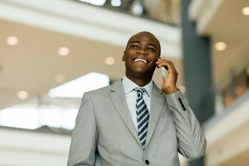 Successful businessman in a suit talking on a smartphone in a modern business center
