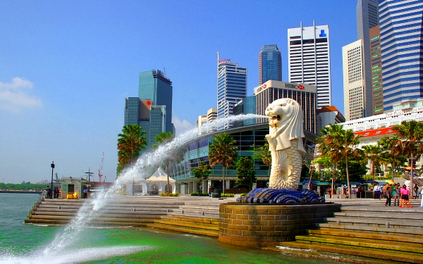 modern skyscrapers in singapore surrounded by palm trees