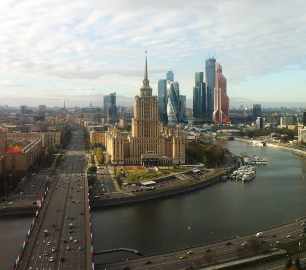 panoramic view of Moscow riverbank with towers and domes under blue sky