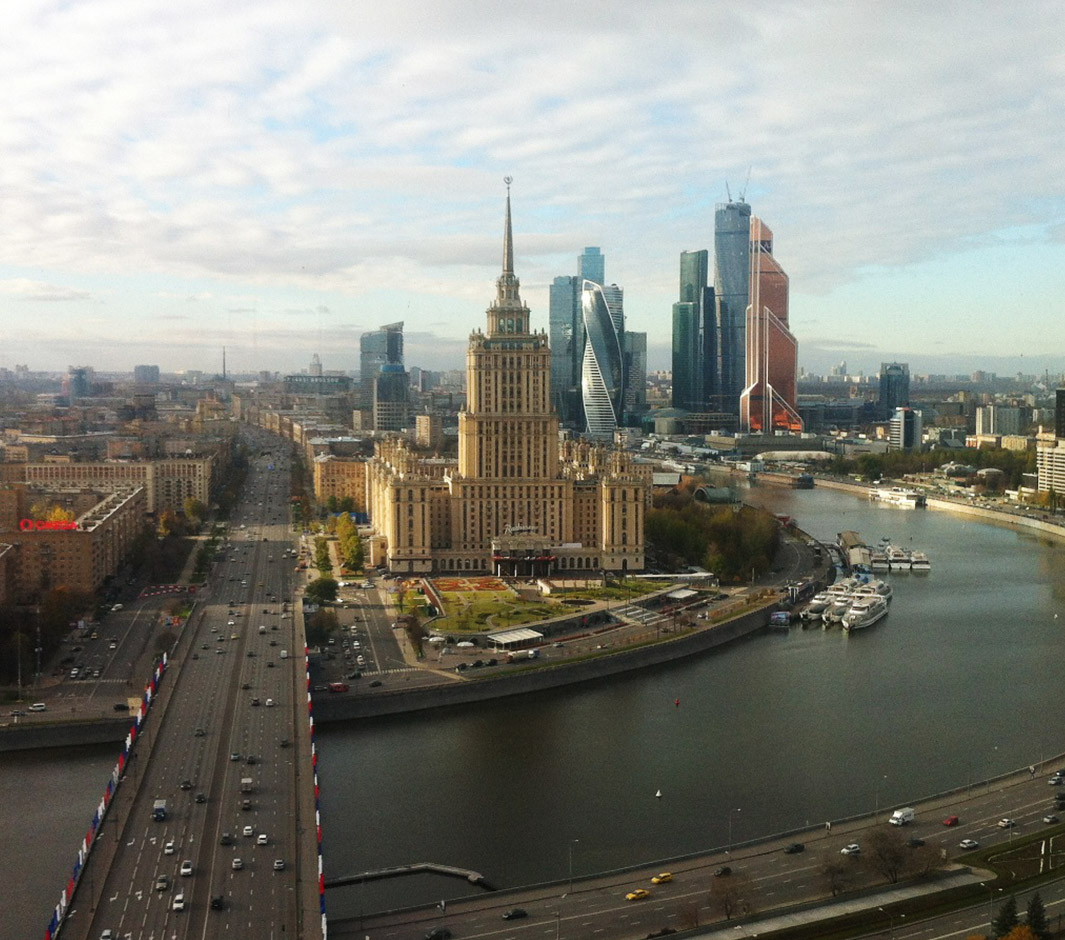 panoramic view of Moscow riverbank with towers and domes under blue sky