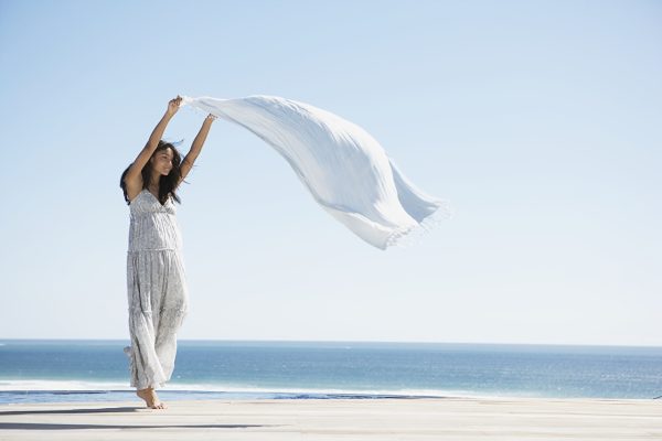 Woman walking on the beach during European vacation — creating unforgettable memories with a travel companion