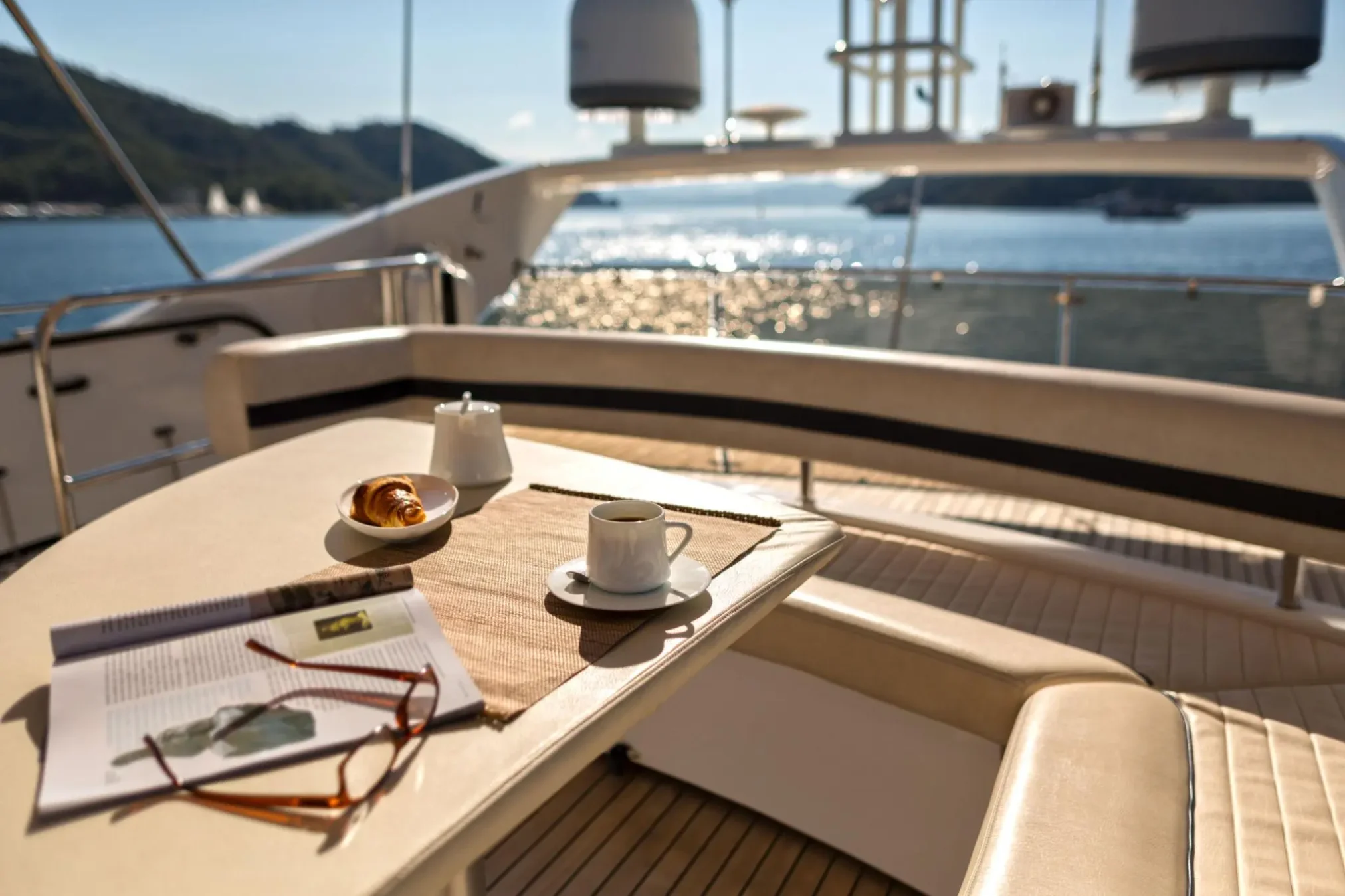 Luxury yacht at sea with coffee, croissant and magazine